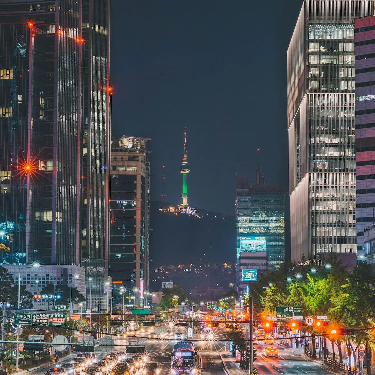 Cityscape at night with illuminated buildings and traffic